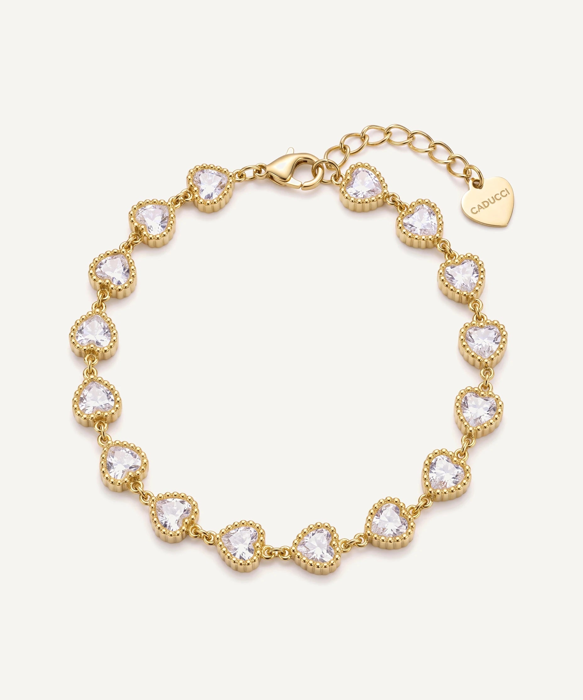 CADUCCI Amore Bracelet in gold with heart-cut crystals and a heart charm engraved with the CADUCCI logo