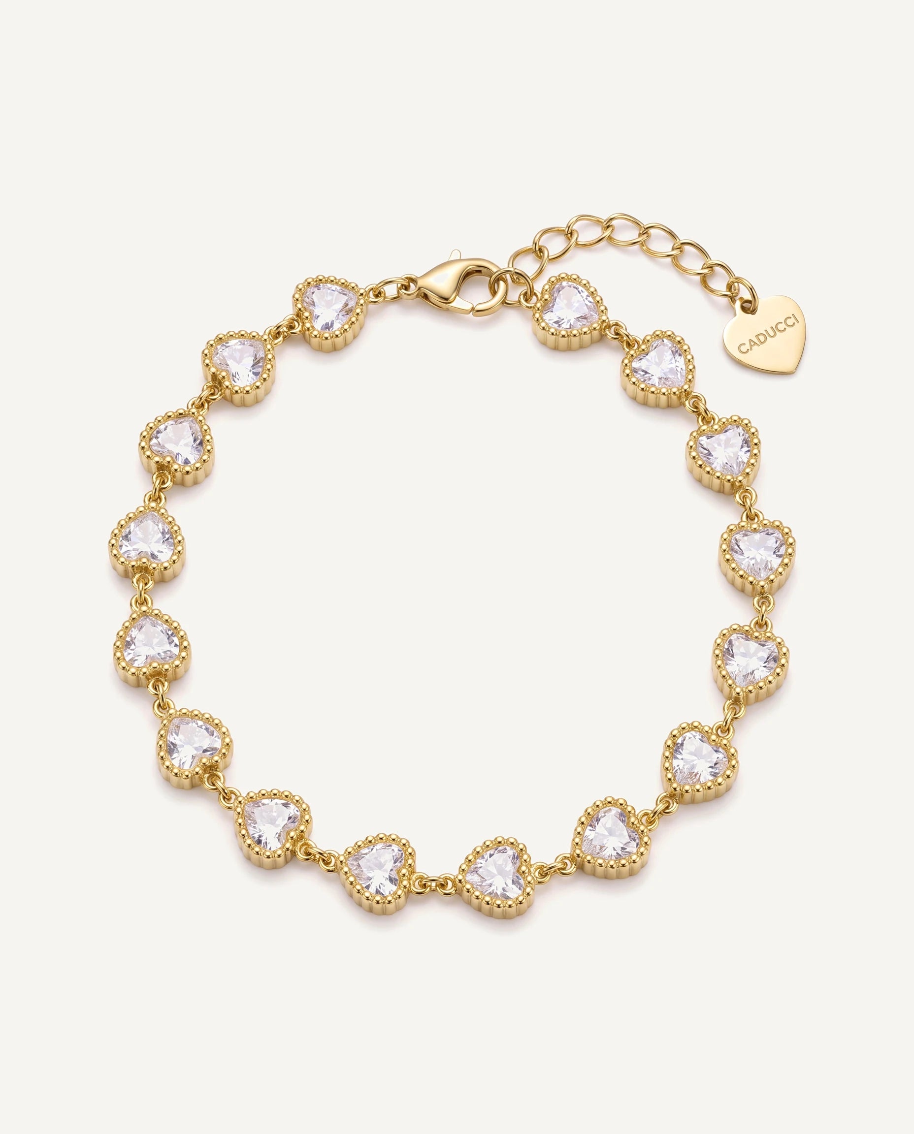 CADUCCI Amore Bracelet in gold with heart-cut crystals and a heart charm engraved with the CADUCCI logo