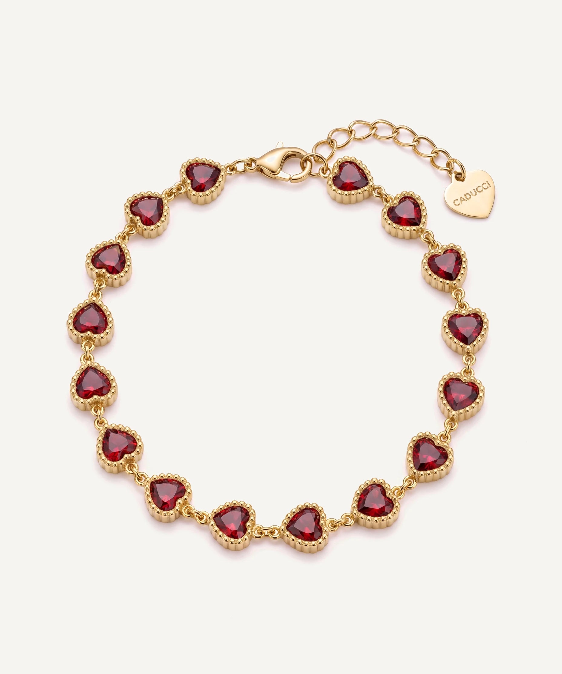 CADUCCI Amore Bracelet in gold with red heart-cut stones and a heart charm engraved with the CADUCCI logo