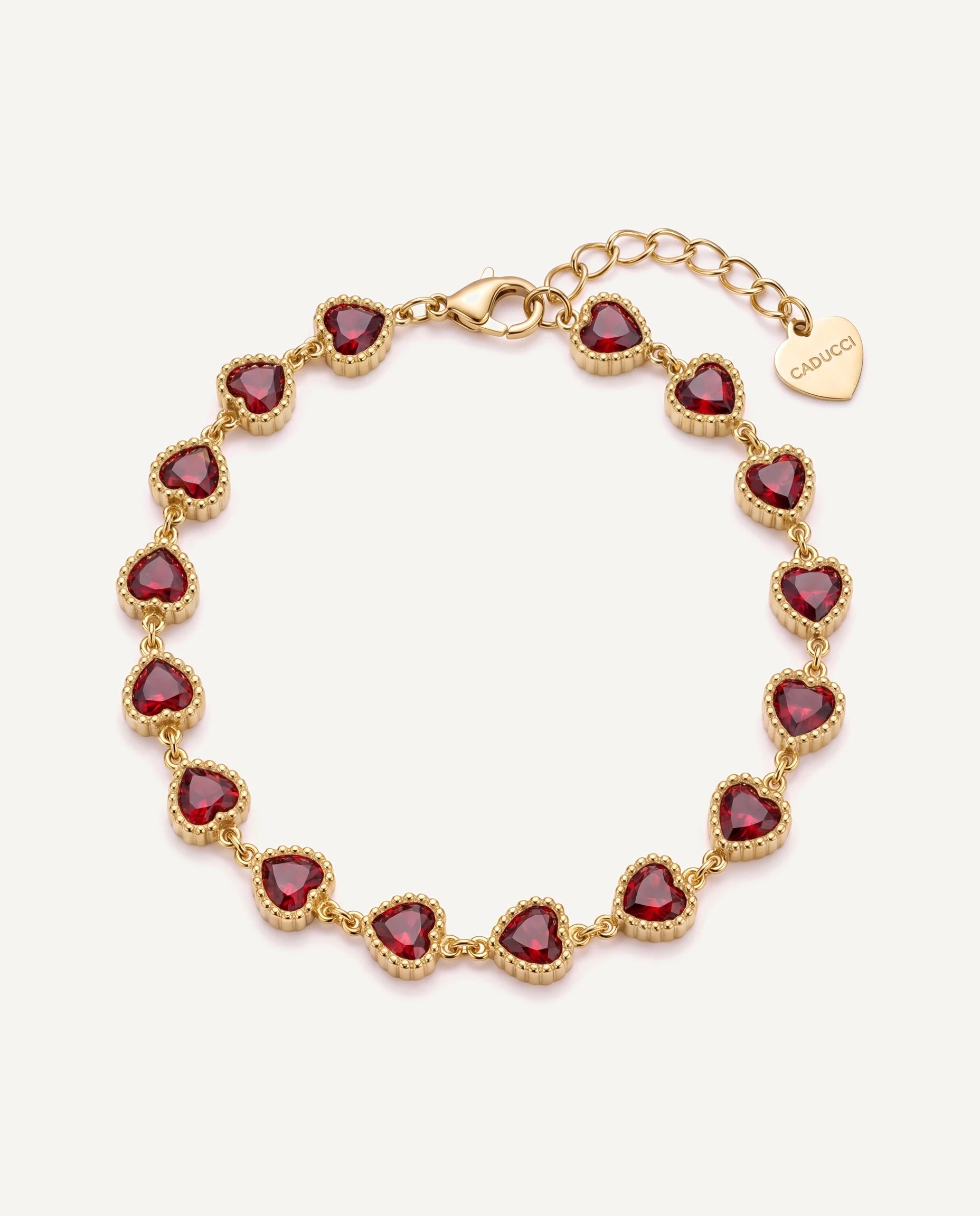 CADUCCI Amore Bracelet in gold with red heart-cut stones and a heart charm engraved with the CADUCCI logo