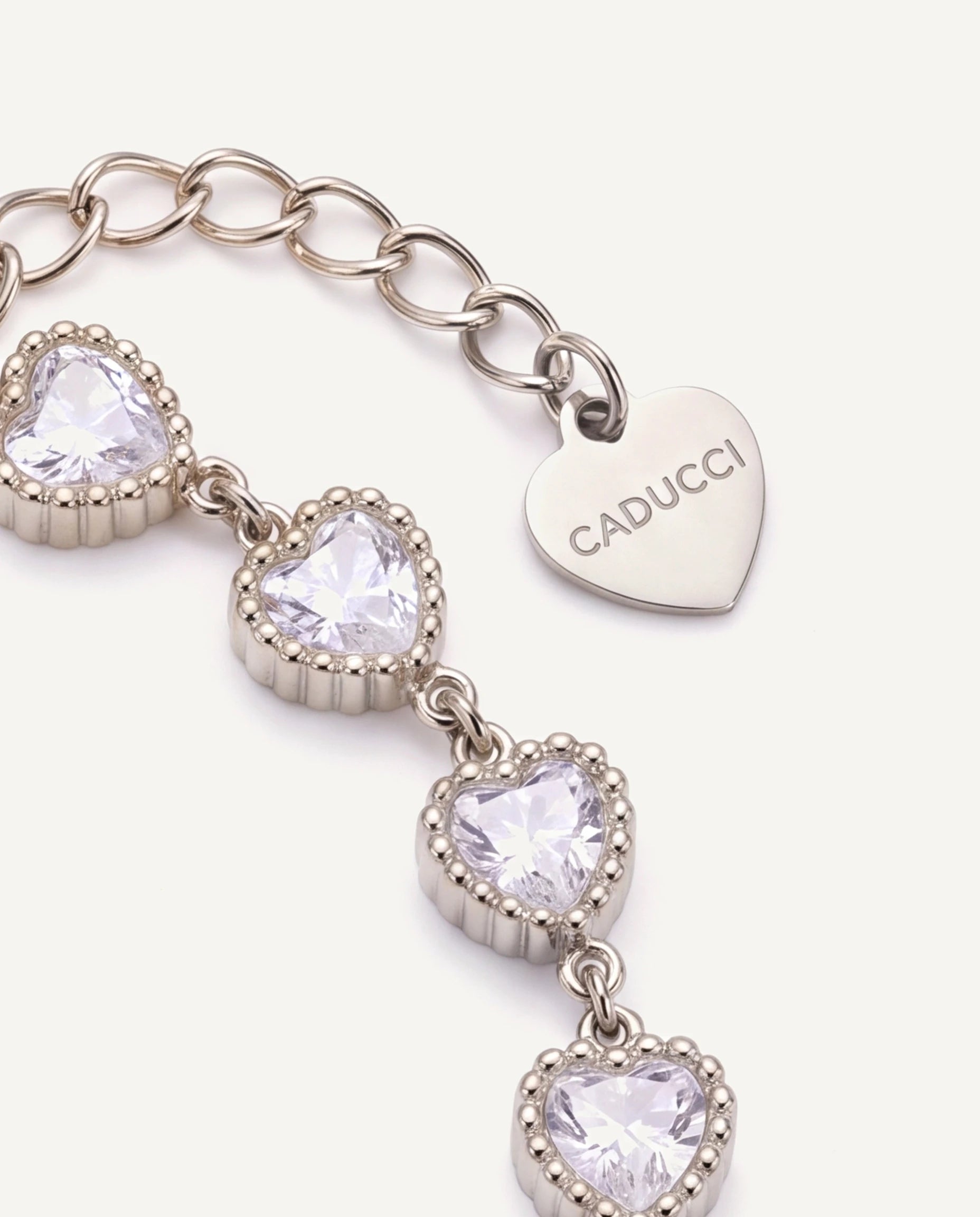CADUCCI Amore Bracelet in silver, close-up of the heart charm engraved with the CADUCCI logo