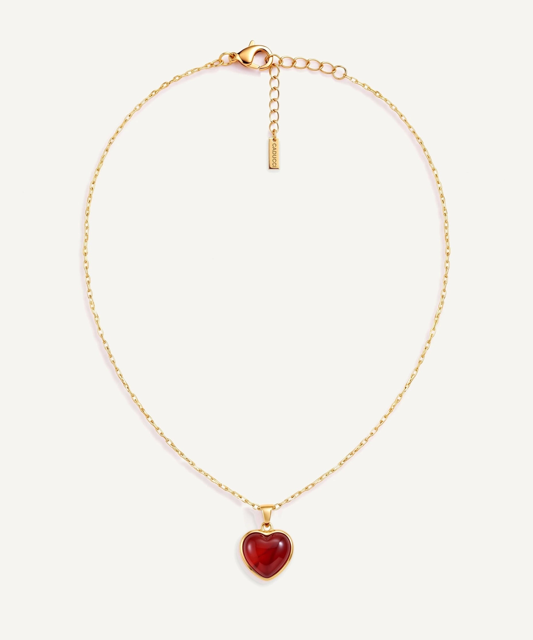 CADUCCI Amore Necklace in gold with a red heart pendant in a smooth bezel and a rectangular tag engraved with the CADUCCI logo