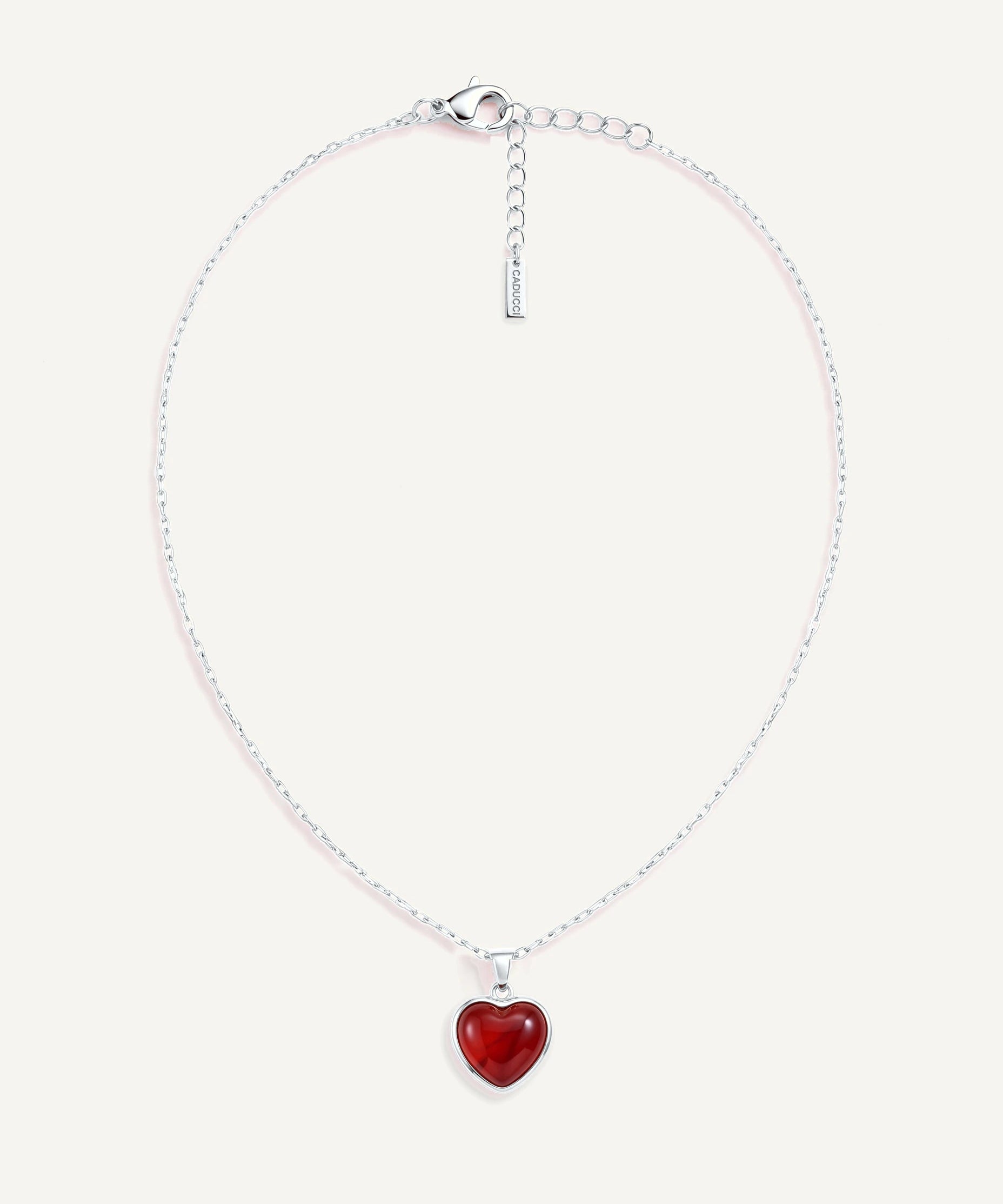CADUCCI Amore Necklace in silver with a red heart pendant in a smooth bezel and a rectangular tag engraved with the CADUCCI logo