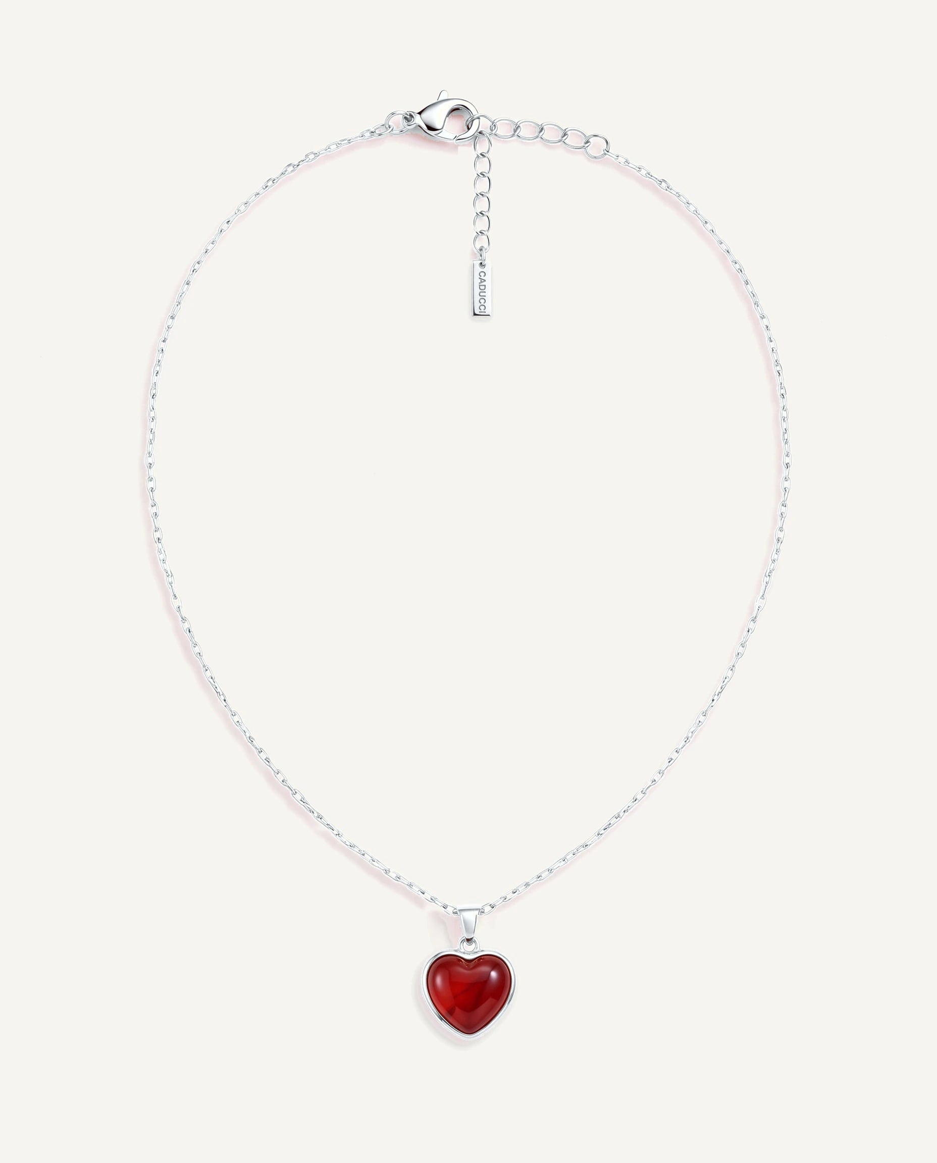 CADUCCI Amore Necklace in silver with a red heart pendant in a smooth bezel and a rectangular tag engraved with the CADUCCI logo