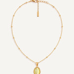 CADUCCI Capri Necklace in gold with an oval pale green cat's-eye pendant in a smooth bezel and a rectangular tag engraved with the CADUCCI logo