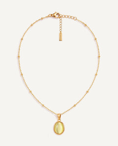 CADUCCI Capri Necklace in gold with an oval pale green cat's-eye pendant in a smooth bezel and a rectangular tag engraved with the CADUCCI logo