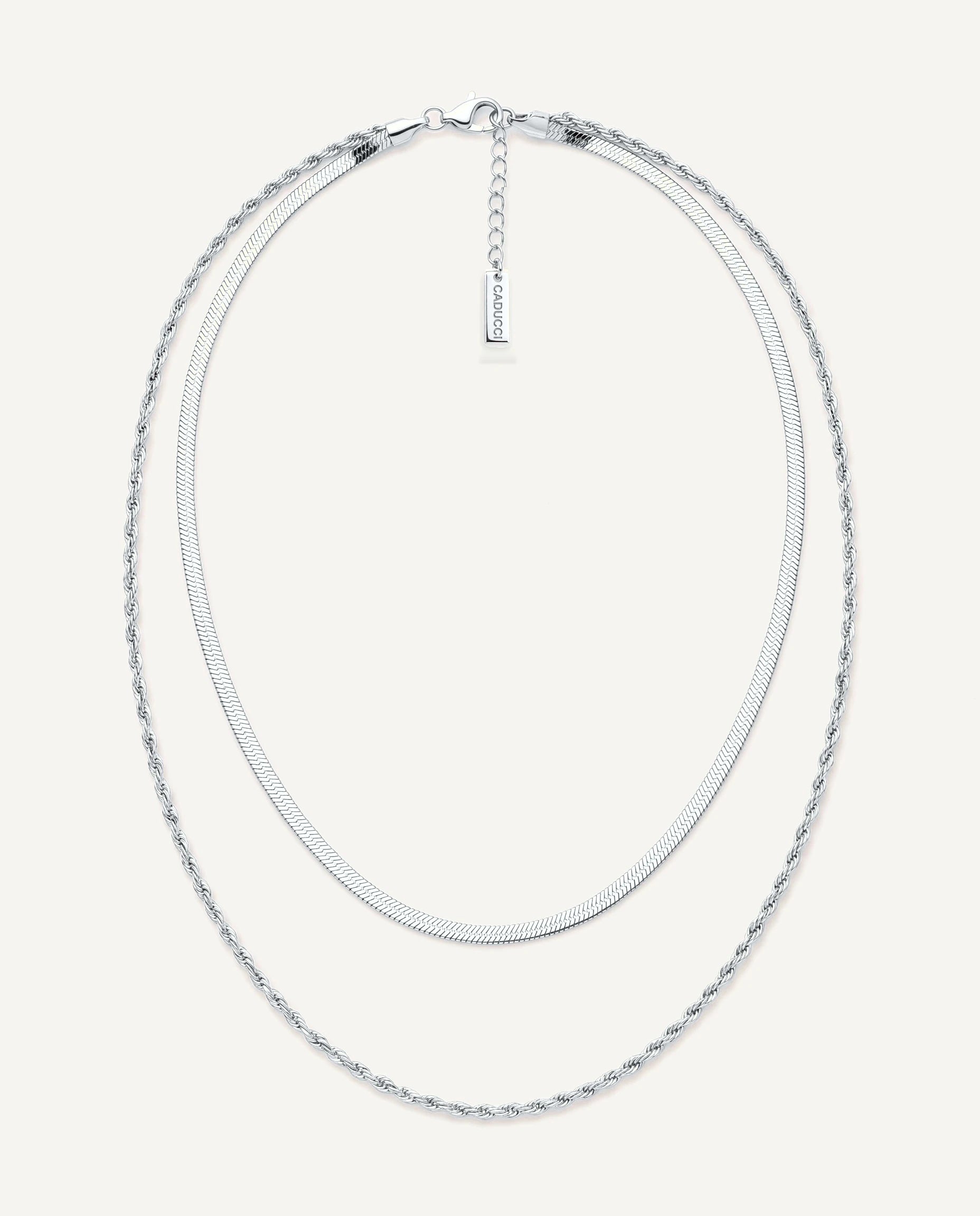 CADUCCI Firenze Necklace in silver, layered: a thin herringbone chain and a fine rope chain, with a rectangular tag engraved with the CADUCCI logo