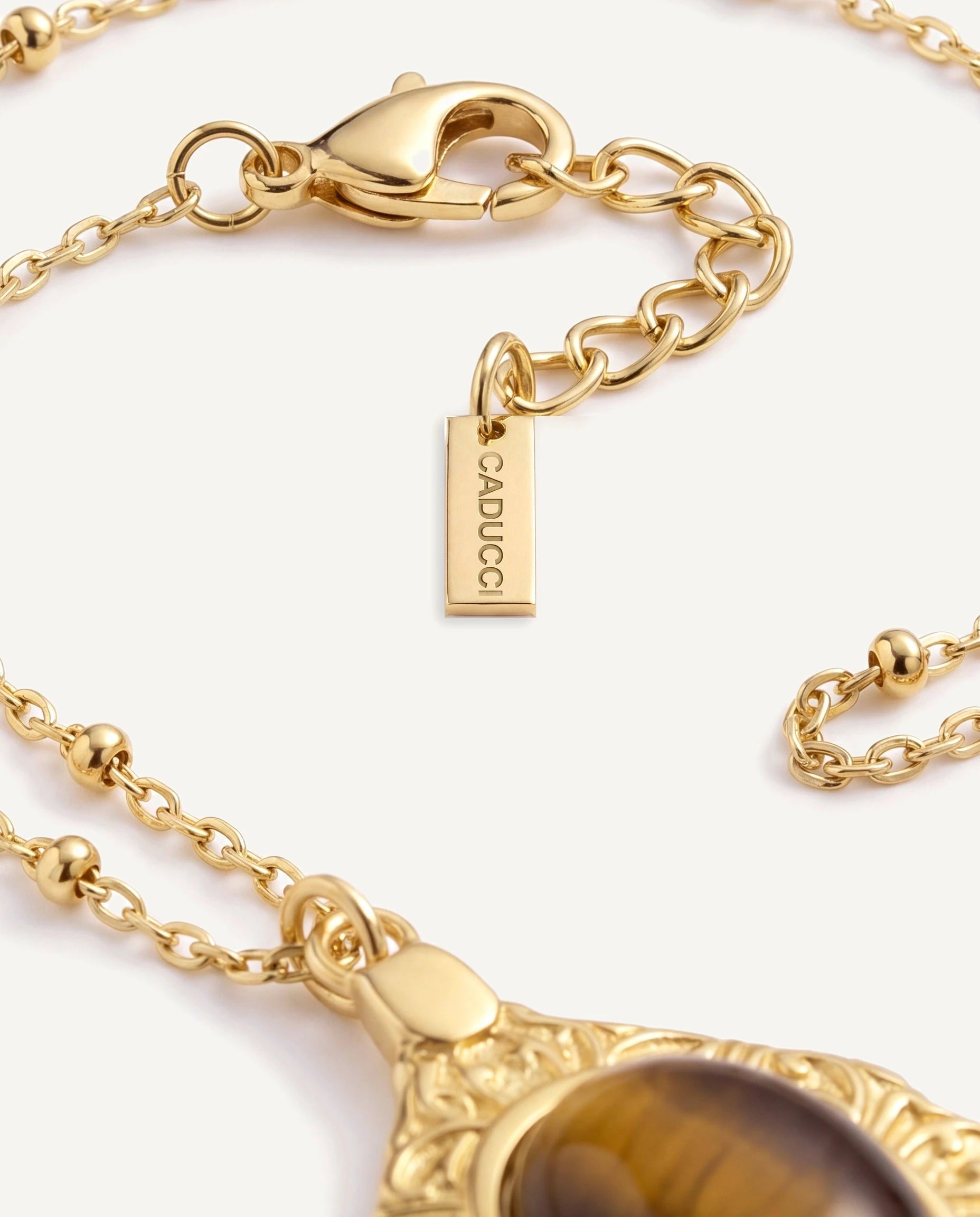 CADUCCI Luna Necklace in gold, close-up of the satellite chain, the clasp and the tag engraved with the CADUCCI logo