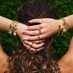 CADUCCI Venezia Bracelet in gold worn with gold rings and bracelets