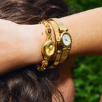 CADUCCI Venezia Bracelet in gold worn in a stack with a vintage gold watch