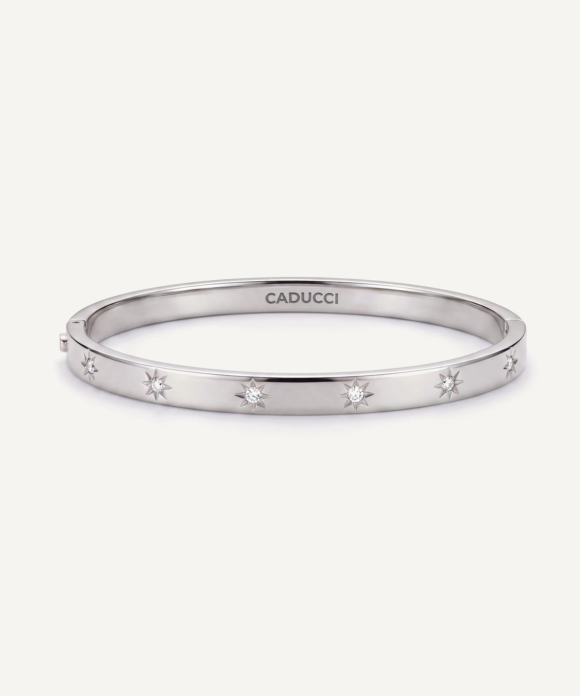 CADUCCI Venezia Bracelet in silver, slim hinged bangle with star-set crystals and the CADUCCI logo engraved inside