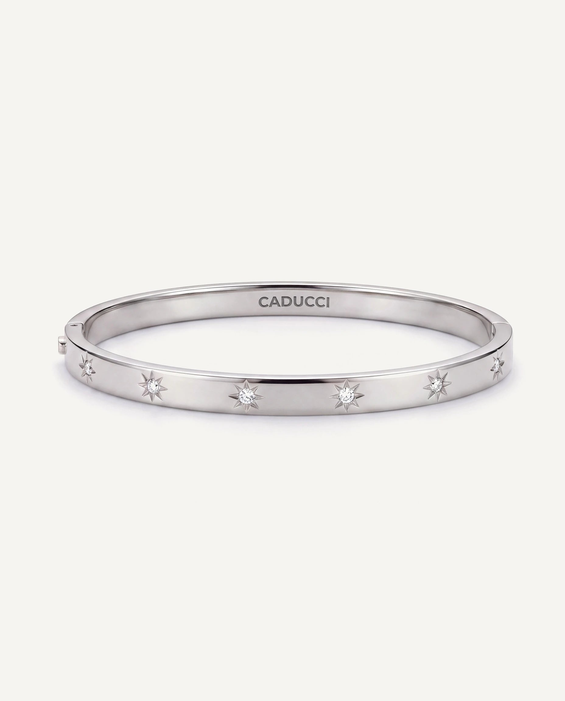 CADUCCI Venezia Bracelet in silver, slim hinged bangle with star-set crystals and the CADUCCI logo engraved inside